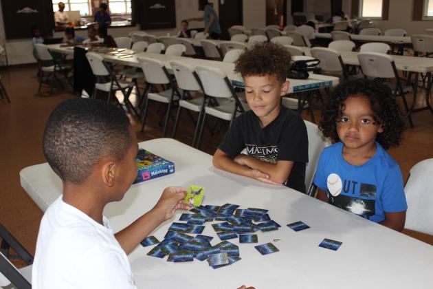 Playing a memory matching game are Leo Sam, Dawson Reed and Easton Celestine at the Kids Summer Camp held at the Southeast Center.