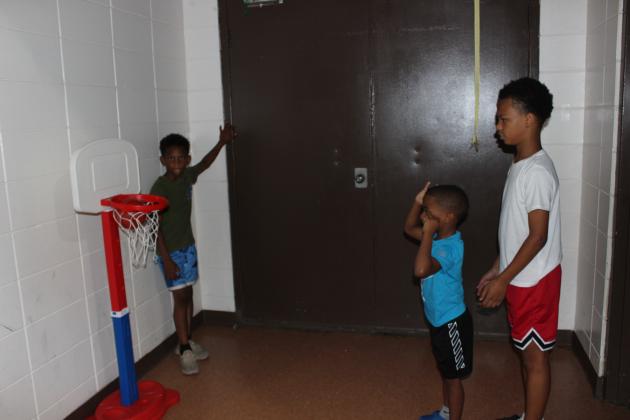 Adrian Guillory, 7, left, Bryden Lafleur, 5, and Brennan Robinson, 12, had a game of basketball going on.