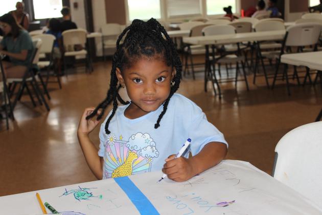 A future artist Aylah Thomas, 5, draws on a drawing sheet.