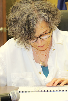 St. Landry Parish School Board member Mary Ellen Donatto looks over a budget document at a meeting Monday in Opelousas. (Photo by Harlan Kirgan)
