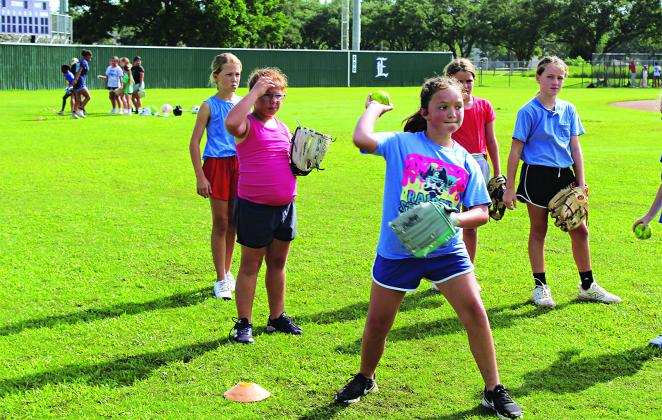 Avenleigh Miller, 9, of Richard, is in line to throw the ball into the catching ball netting. There were 36 participants at the softball camp. (Photo by Myra Miller)