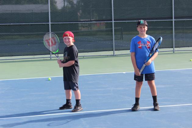 Bodhi Hannon, 9, and Luke Sattler, 9, are gearing up and getting ready for tennis instructions and drills from their instructor Eli Thomas.