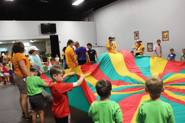 Children enjoyed an indoor game activity with a parachute at Summer Surge at New Hope Fellowship.