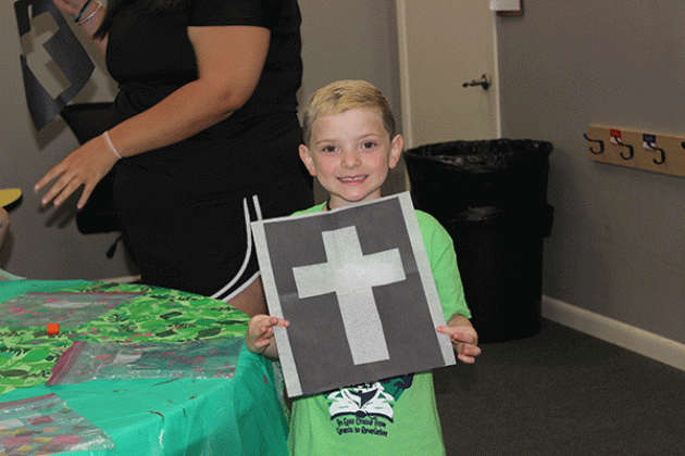 Kutter Hyde, 5, shows off his finished product during arts and crafts at New Hope Fellowships’ Summer Surge camp.
