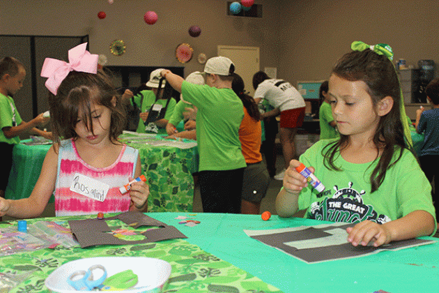 Rosalind Huckaby, 5, left, and Adaleigh Matherne, 6, were crafting a cross at Summer Surge at New Hope Fellowship Church.