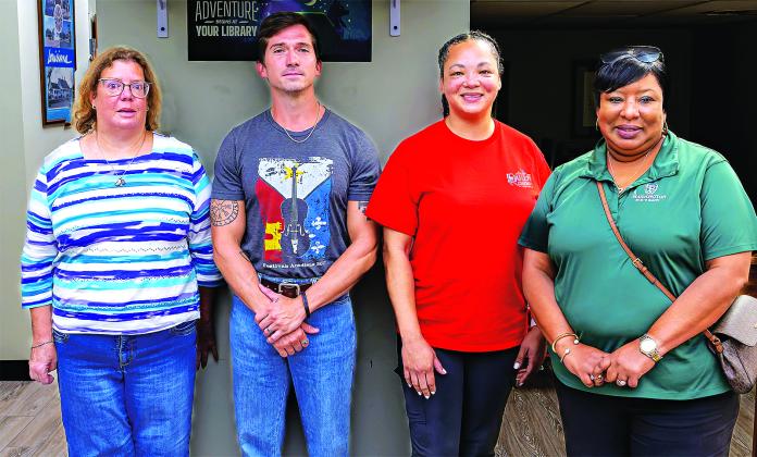 Tony Baltakis, right, president of the Eunice Library Board of Control, beings a meeting to organize a Eunice Friends of the Library on Thursday. The group is formed to become a fundraising arm of the library. The meeting also included electing officers. They are, in the photo at right, and from left, April DeRouen, vice president; Kyle Huval, president; Patina Mitchell, treasurer; and Roxanne Jordan, secretary. Top photo by Harlan Kirgan and photo at right by David Simpson.