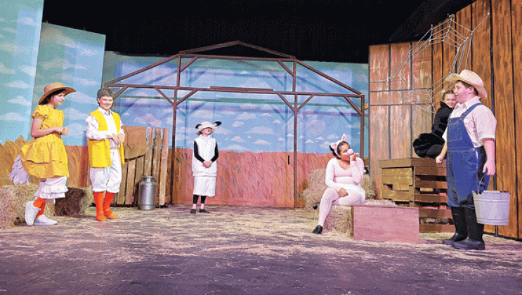 This scene from “Charlotte’s Web” shows some of the barnyard animals at the Zuckerman farm and Lurvy, the farm hand, played by Everett Reppond.  Goose and Gander are played by Elle Soileau and Issack Henderson; Lamb is played by Bailey Fruge. (Submitted photo) 