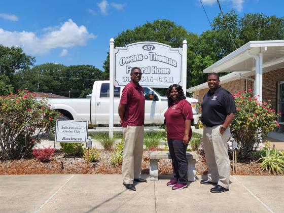 Owens-Thomas Funeral Home located at 437 Moosa Boulevard is the recipient of the Business Garden of the Month presented by the Bulb &amp; Blossom Garden Club. The business features hosta, fox tail ferns, Knock out roses, azaleas, variegated daniella,  variegated ginger, plumbago, and zinias. From left, are Ezekiel Thomas Jr., Chiquita Thomas and Ezekiel John Henry Thomas.