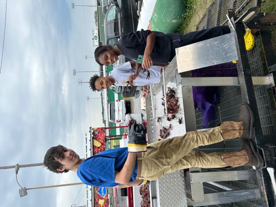 rom left are  Eunice High FFA members Zack Pesina, Kerstun Ned and Alivia Caesar at a crawfish boil fundraiser.