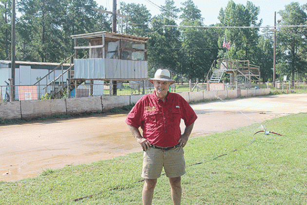 Richard Loveless is pictured as the new sprinkler system waters down the track at Turkey Creek. He is leasing the track from the village on a yearly basis with hopes of expansion. (Gazette photo by Tony Marks)