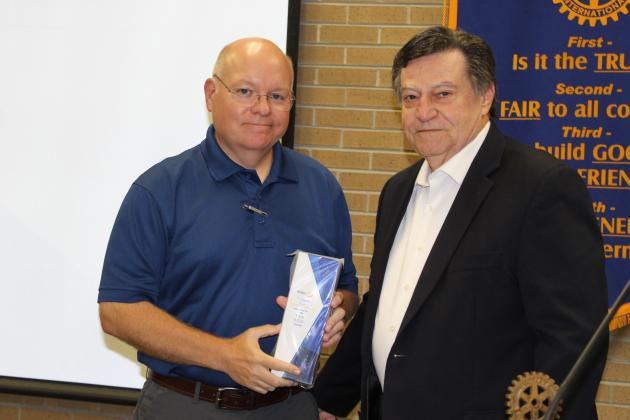 Van Reed is named the Rotarian of the Year. Presenting him with an award is outgoing Rotary Club President Ellis Daigle.