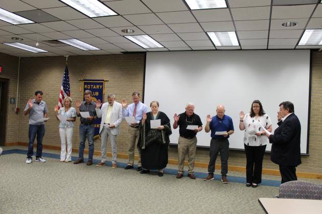 Retired Disrict Judge and past Rotary President Ellis Daigle swears in the Rotary Club officers and board members. From left are Alex Morris, Kayla Heinen, Rev. Andrew Bates, Willie Bergeron, Dwight Jodon, Pat Dossman, Shirley Vige, Van Reed and Erika Fontenot.