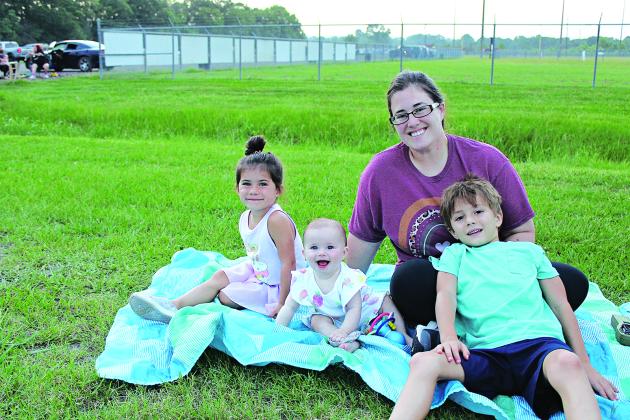 The Vidrine’s from Vidrine sit upon a large beach towel prior to the fireworks display Friday. From left are Bailey, Bethany, Brittany and Bodhi.