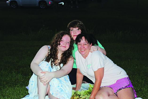 Stevie, Andrew, and Jackie Oberste of Eunice are among the hundreds of 4th of July fireworks fans at the Eunice Recreational Complex.