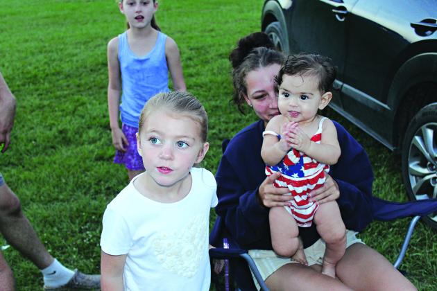 Left, in back, Ivy LaFleur of Mamou, and directly in front, from left, are Henslie Johnson of Bayou Chicot, Aleira Holston and Averie Lanclos, 7 months, both of Bayou Chicot, arrive early Friday to watch the fireworks.