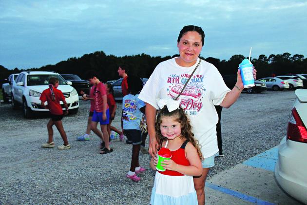 Enjoying iced cold sno cones are Josette Fruge and Danika Fruge, 4, Friday evening at the Eunice Recreational Complex.