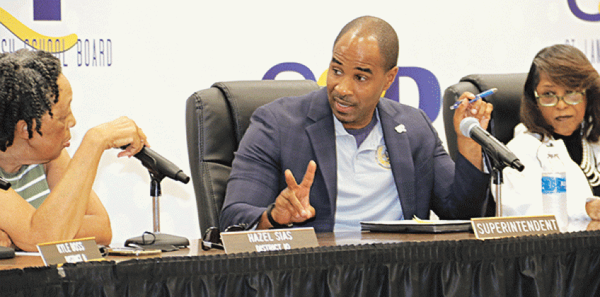 Milton Batiste, center, St. Landry Parish school superintendent, discusses the district personnel office staffing with Board members Hazel Sias, left, and Joyce Haynes, Board president. (Photo by Harlan Kirgan)