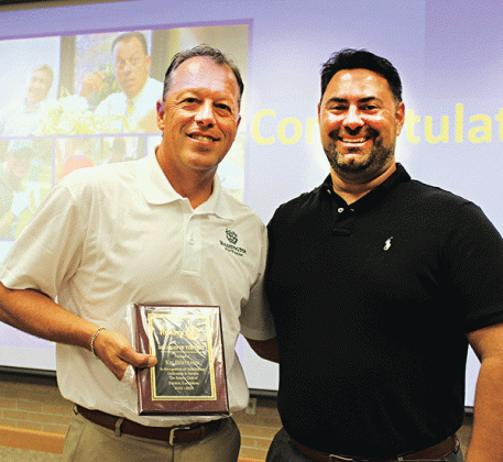 Past Rotary President Jacob Bergeron, right, presented the Rotarian of the Year award to Kip Bertrand.