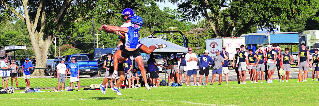 Blue Jay Wyatt Dubois tangles with Opelousas Catholic player during the 7-on-7 game that was part of a 16-team tournament on July 16.   (Photos by Amy Myers)