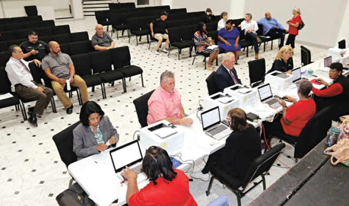 Qualifying opened at 8 a.m. Wednesday and continues through Friday the Delta Grand Theater in Opelousas. Candidates are show seated with clerks. (Photo by Harlan Kirgan)