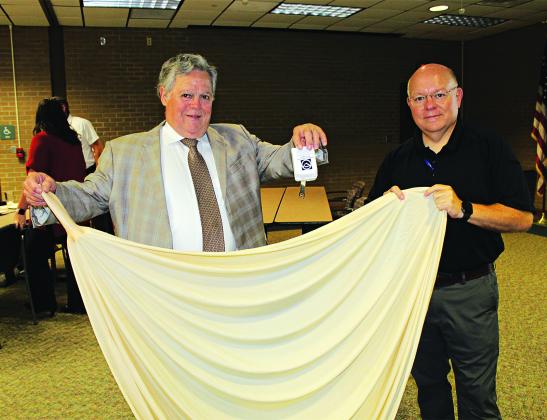 Holding up a radiosonde, a weather instrument, and a weather balloon are John Pucheu and Van Reed. (Photos by Myra Miller)