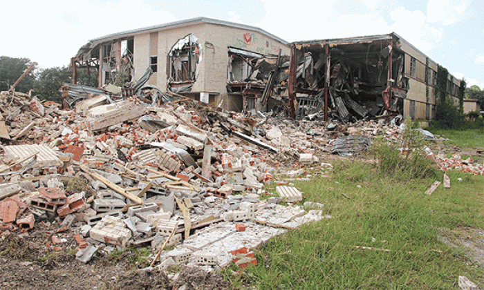 Moosa Memorial Hospital is fast disappearing as demolitions continues. The building was vacant since 2006 and in June St. Landry Parish President Jessie Bellard announced parish government would do the work. Bellard estimated the building is about 80,000 square feet. Much of the debris is being recycled. Bellard said metal is being sold. Bricks and concrete are being processed for road material, he said. (Photo by Harlan Kirgan)