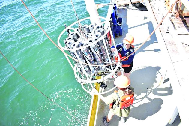 Students Abby Roche and Lily Tubbs retrieve the conductivity, temperature, depth sensor package after profiling dissolved oxygen at a station on the Louisiana Universities Marine Consortium Shelfwide Hypoxia Cruise. (Photo by Cassandra Glaspie | LUMCON/LSU)
