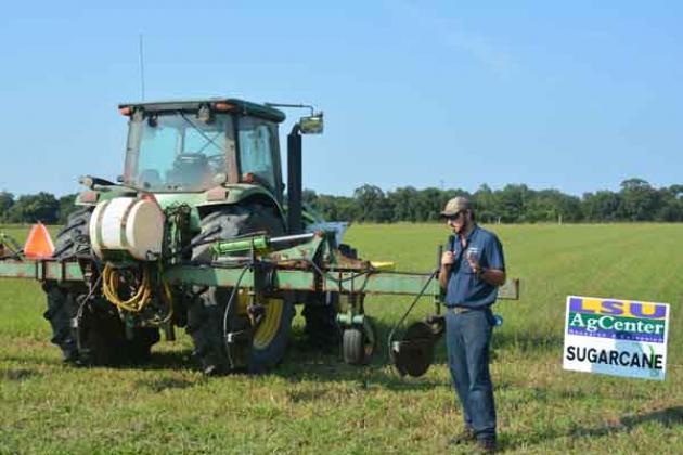 Iberia Parish sugarcane grower Taylor Blanchard displays a no-till fertilizer implement that applies fertilizer to the top of the rows to allow for more direct applications with less soil disturbance during a field day focused on sugarcane at the LSU AgCenter Iberia Research Station on July 27. (Photo by Derek Albert/LSU AgCenter)