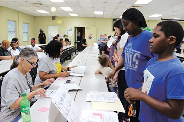 Central Middle School held its fifth and sixth grade school registration Monday. Many students along with their parents or guardians went through the process of registration, paying registration fees, receiving schedules and registering for spirit shirts. At the registration packet review table are Cynthia Guillory, left, and Sheila Janice. In front of the table are Brycen Honore, a fifth grader, and his mother Lisa LaFleur. The first day for public schools in Eunice is Aug. 11.  (Photo by Myra Miller)