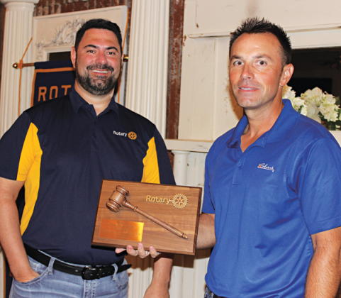 Jacob Bergeron, president of Eunice Rotary Club, presents a plaque of appreciation to past president of Rotary Club Coby Clavier. (Photo by Myra Miller)