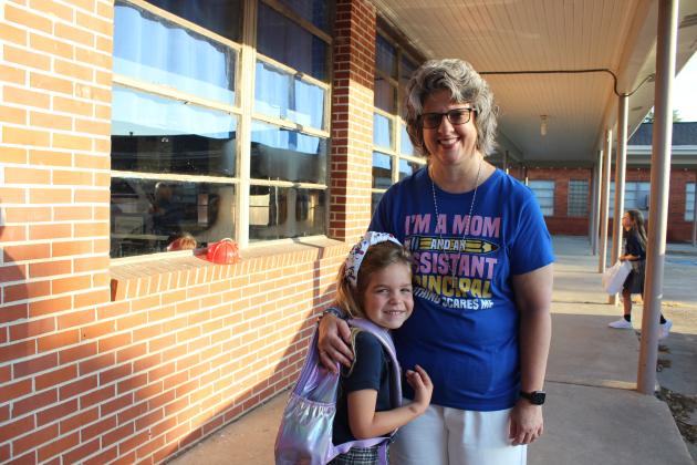 Greta Smith, first grader, receives a warm welcome from Nicole Sonnier, St. Edmund Vice Principal.