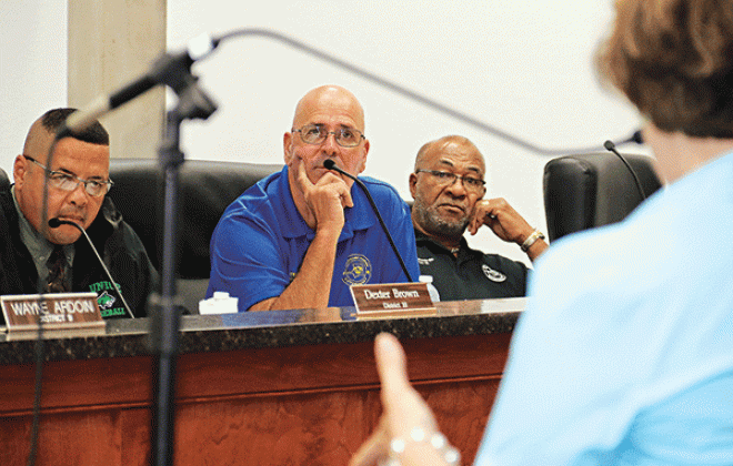 St. Landry Parish Council members, from left, Dexter Brown, Timmy Lejeune and Jimmie Edwards listen to human resource expert Becky Rogers at a special meeting Wednesday. The Council tied 6-6 on whether to hire Rogers and another vote is set for this Wednesday’s meeting. If hired, Rogers would investigate firings by Parish President Jessie Bellard. (Photo by Harlan Kirgan)
