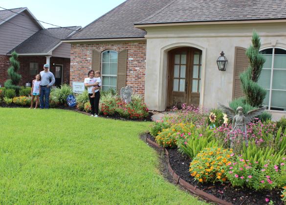 The Residential Garden of the Month marker was presented to Sage and Emily Prudhomme for their beauty seen on their front lawn at 1350 College Road. The flowering landscaped beds features spiral junipers, foxtail ferns, purple Buddies, vincas, zinnias, Wintergreen box woods, Shi-Shi, celosia, and varigated flax lily. From left are Julianna, Sage, Emily and Talan Prudhomme.