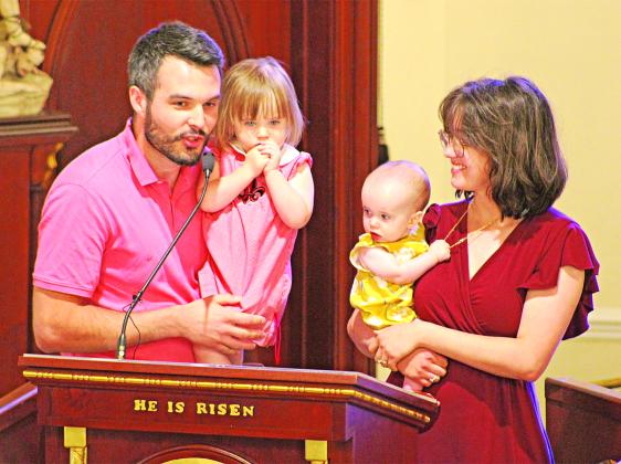 The Stansbury Family, Ryan and Sophie and their daughters Cecilia and Charlene, address the crowd at the annual Charlene Richard Mass. The family prayed to the “The Little Cajun Saint” for a healthy birth of their daughter Charlene. (Photos by Claudette Olivier/The Church Point News)
