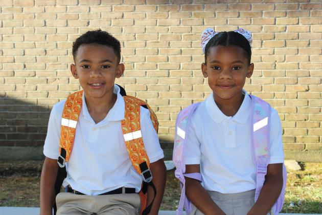Ezra Gallow, a third grader, left, and Vaida Gallow, a first grader, arrive early Thursday at Eunice Elementary.