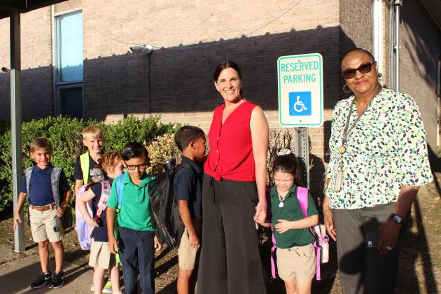 Left, Eunice Elementary Principal Mary Dupre stands with a group of kindergarten, first, and second grade students on the first day of school Thursday. At far right is Gloria Frank, a paraprofessional on campus.