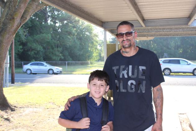 Keegan Aucoin, a second grader at Eunice Elementary, arrives at school with his father Cody Aucoin.