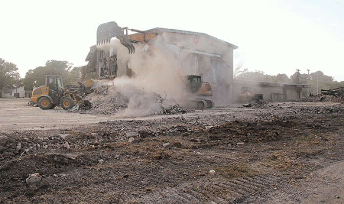 The dust was flying as heavy equipment worked on the demolition of the old Moosa Memorial Hospital on Tuesday afternoon. By Thursday, the central two-story portion of the building was left standing alone. Another portion of the structure remained on the north side. St. Landry Parish Government crews are doing the demolition. (Photo by Harlan Kirgan)