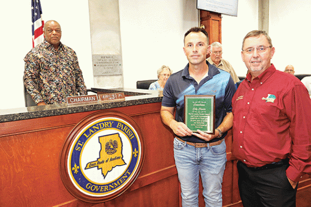 Former St. Landry Parish Council member representing District 13 Coby Clavier holds a plaque recognizing his service at Wednesday’s Parish Council meeting. From left, are Jerry Red, Council chairman; Vivian Olivier, Council member; Clavier; Wayne Ardoin, Council member; Jessie Bellard, parish president; and Timmy Lejeune, Council member. Clavier was elected to two terms, but resigned recently citing conflicts with his job. (Photo by Harlan Kirgan)