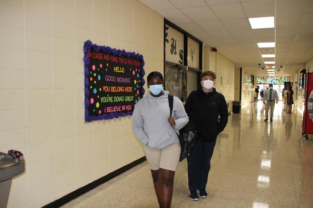 Mia Hardy, left, and Alex Fuentes, both sophomores at Eunice High School, arrive early Wednesday morning for their first day of classes.