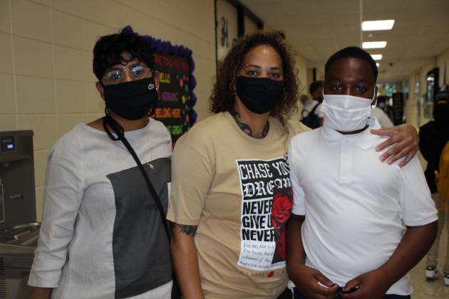 TaClinton  Ceasar, a freshman at Eunice High, is greeted by his teachers LaRhonda Simpson and Keenya Alfred in the hallway Wednesday.