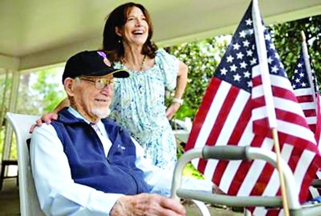 World War II veteran and Bataan Death March survivor James Bollich and his daughter, Melinda Gilbert, watch as a car parade passes by to celebrate his 104th birthday on Friday, Aug. 15,, at his home in Lafayette. (Acadiana Advocate photos By Brad Bowie)