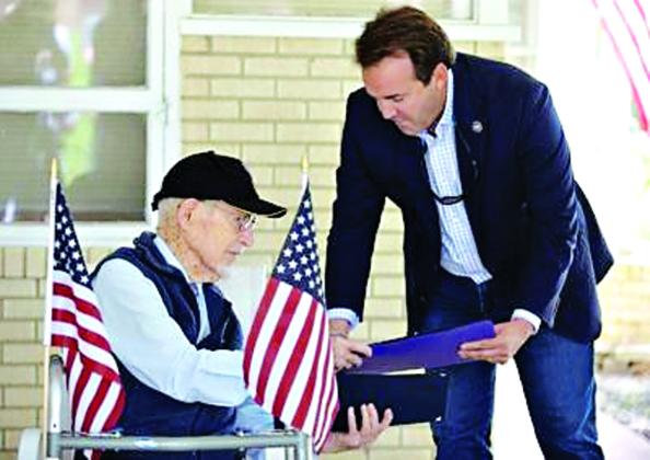 Representative Phillip R. DeVillier, the 70th Speaker of the Louisiana House of Representatives, right, presents World War II veteran and Bataan Death March survivor James Bollich with a proclamation during a celebration of Bollich’s 104th birthday on Friday, Aug. 15, at his home in Lafayette. (Acadiana Advocate photos By Brad Bowie)