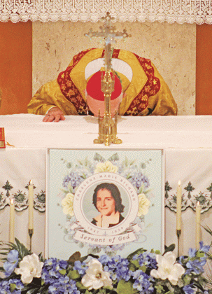 Bishop J. Douglas Deshotel of the Diocese of Lafayette kisses the altar at St. Edwards Church at the start of the annual Charlene Richard Mass. The Mass was celebrated on Aug. 12. Deshotel  led the Cause for Canonization Ceremony for Charlene to officially close the diocesan phase of the process. (Photo by Claudette Oliver/Crowley Post-Signal)