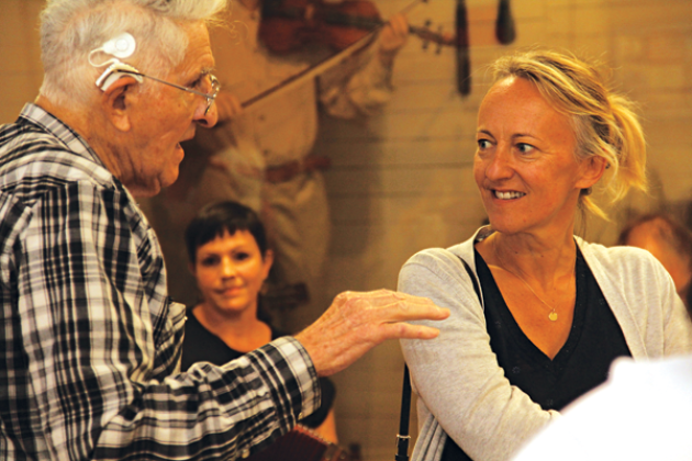 Retired accordion-maker Larry Miller, left, talks with Barbara Boltoukhine, of France, at the CFMA Cajun Music Hall of Fame and Museum on Sunday. Scalamogna is a representative for the Louisiana Office of Tourism. In the background is Sarah Savoy, who performed with Cameron Fontenot. (Photo by Harlan Kirgan)