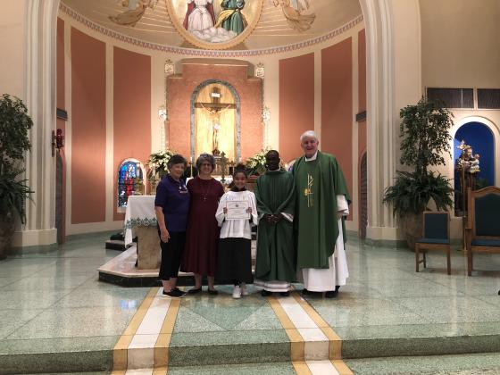 St. Edmund students participated in the National CDA Education Contest. From left, are Lynn Pavich, Nicole Sonnier, Zoe Ardoin, the Rev. Raymond Ssebina Musisi, and the Rev. Hampton Davis.