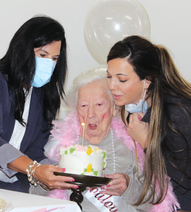 Mary Tate Collier, a resident at Eunice Manor, celebrated her 100th birthday with a party Friday. Collier and her late sister, Ethel Tate, owned and managed Mary Collier Fashions from 1966 until 1984. Blowing out her candle on her birthday cake with her are Nickie Toups, administrator, left, and Lauren Lirette, minimum data set nurse at Eunice Manor.