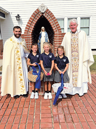 One of the beautiful traditions at St. Edmund Catholic School is the Eucharistic Procession at the beginning of each school year. Following the Mass for the new academic year, the Blessed Sacrament is brought in procession from the Church and placed in the Tabernacle of the school chapel. From left, are the Rev. John Dugas, Ayda Fuselier, Mallory Borne, Clare Fruge and Rev. Hampton Davis. (Submitted photos)