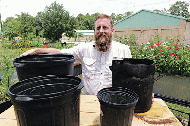 LSU AgCenter horticulture agent Will Afton stands with some different types of containers that can be used for gardening. (Photo by Randy LaBauve/LSU AgCenter)