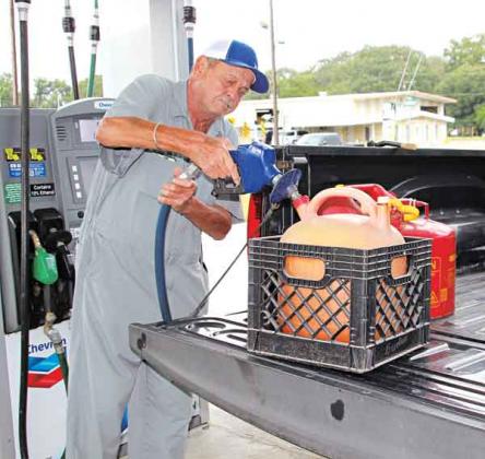 Randy Fontenot of Lanse Meg fills gas cans to run a home generator in preparation for Hurricane Ida expected on Sunday. (Photos by Myra Miller)